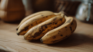 Close-up image of overripe brown bananas on a wooden countertop, soft natural light, cozy kitchen vibe.