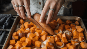 Peeling a sweet potato has always felt therapeutic to me. The slow scrape of the peeler… the soft thump when cubes hit the tray… the gentle glow of orange. I slice the onion thin and scatter it around, almost like letting the day fall apart around me so I can rebuild something warm. Then I drizzle oil, sprinkle salt, and toss everything with my hands. There’s something grounding about using your hands — the textures, the warmth, the simple act of touching food. Into the oven they go: 400°F (200°C), 25–30 minutes. As the vegetables roast, the house fills with a smell that feels like the emotional version of a blanket.