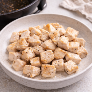 Cook the protein first and remove it from the pan once just cooked. Letting it rest prevents dryness and removes pressure from timing later.